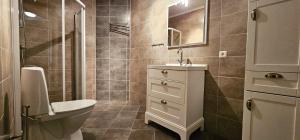 a bathroom with a toilet and a sink and a shower at Modern villa with sea view in Svanesund SE09101 in Svanesund +26 photos