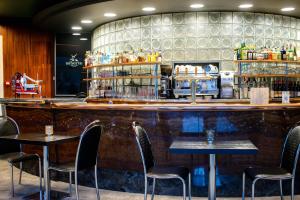 a bar with chairs and tables in a restaurant at Hôtel La Réserve in Gérardmer +66 photos