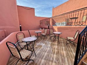 a patio with tables and chairs on a balcony at Riad al anwar in Rabat