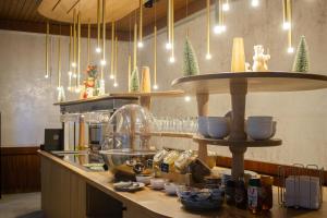 a kitchen with a counter with a counter top with food at Hôtel La Réserve in Gérardmer