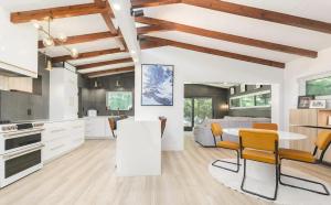 Una cocina y una sala de estar con mesa y sillas. en Charming Four-Bedroom Coastal Retreat Near Neptune Beach, en Neptune Beach