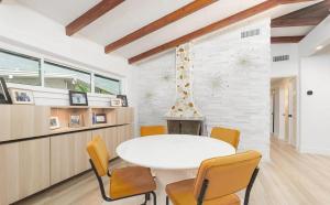 Un comedor con una mesa y sillas blancas. en Charming Four-Bedroom Coastal Retreat Near Neptune Beach, en Neptune Beach