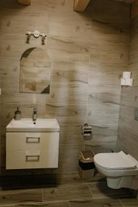 a bathroom with a sink and a toilet at Sosnowy Domek Parter Zator Energylandia Graboszyce in Graboszyce