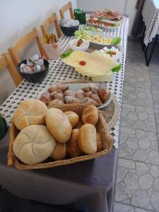 a table topped with baskets of bread and other foods at Pensjonat Magdalena - w cichym i spokojnym miejscu - zwierzęta akceptowane, bezpłatny parking in Szklarska Poręba