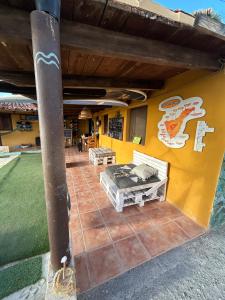 a patio of a house with a bed on it at The Tree House Surf Camp in Adeje