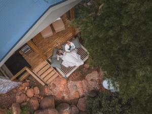 an aerial view of a bride and groom on a deck at Barn Owl Cabin at Vrolikheid Landgoed in Tulbagh