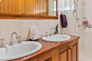 a bathroom with two sinks and a mirror at Maureens Retreat in Eureka +8 photos