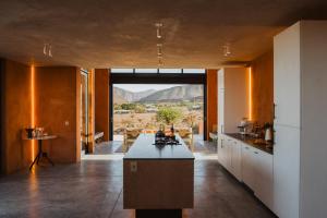 a large kitchen with a view of the desert at Prince Albert Tall House in Prince Albert