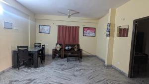 a dining room with a table and chairs at Imperial Homestay in Patna