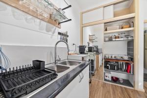 a kitchen with a sink and a stove at Maureens Retreat in Eureka