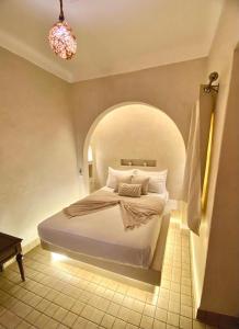 a bedroom with a bed with an arched ceiling at Riad Oum h&N in Marrakesh +32 photos