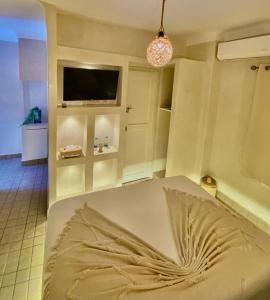 a living room with a bed and a tv at Riad Oum h&N in Marrakesh