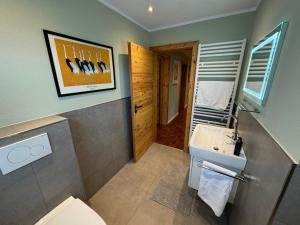 a bathroom with a toilet and a sink at Eden Escapes in Olsberg +66 photos
