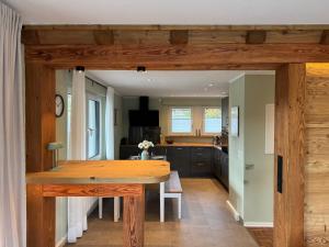 a kitchen with a wooden table in a room at Eden Escapes in Olsberg