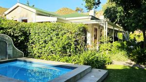 a small swimming pool in front of a house at Montagu Vines Guesthouse in Montagu