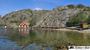 a house on the shore of a body of water at Cottage with Private Shoreline in Boxvik SE09128 in Nösund +18 photos