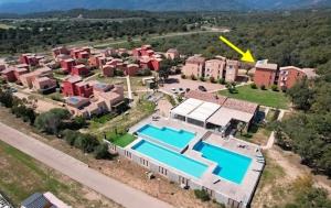 an aerial view of a house with two swimming pools at Appartement T2 moderne - Résidence Lecci - Piscines & proche Mer in Lecci