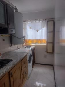 a kitchen with a sink and a washing machine at Mendoza in Barraquero +8 photos