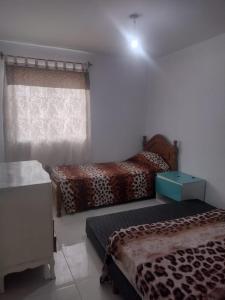 een slaapkamer met twee bedden en een raam bij Mendoza in Barraquero