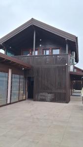 a building with a fence in front of it at Baile Figa-Terasa Spa Cazare in Agrişu de Sus