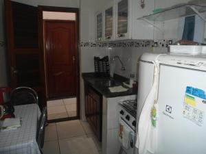 een keuken met een witte koelkast en een spoelbak bij Kit Net, No Centro Comercial de Belém in Belém