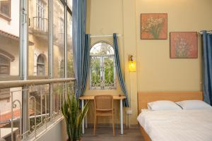 a bedroom with a bed and a desk and a window at Four Seasons Serenity Studio - SDhousing branch in Hanoi