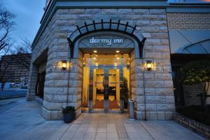 a entrance to a building with a sign on it at Dormy Inn Express Koriyama in Koriyama