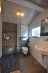 a bathroom with a shower and a toilet and a sink at Hotel Zum Stern in Rauischholzhausen +15 photos