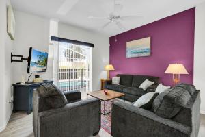 a living room with two couches and a tv at Much Needed Private Relaxation Home in Davenport