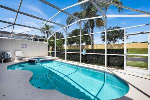 a swimming pool in a building with a large window at Much Needed Private Relaxation Home in Davenport