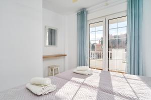 a bedroom with a bed with two towels on it at Apto 5 Almoraide Suites in Nerja +23 photos