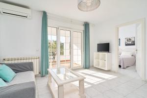 a living room with a couch and a table at Apto 5 Almoraide Suites in Nerja