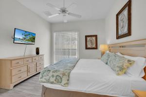 a bedroom with a large bed and a ceiling fan at Much Needed Private Relaxation Home in Davenport +17 photos