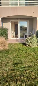 a house with a lawn in front of it at Studio face à l océan in Les Sables-dʼOlonne