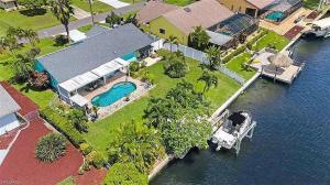 an aerial view of a house with a boat in the water at Summer Getaway (Gulf-access retreat) in Cape Coral