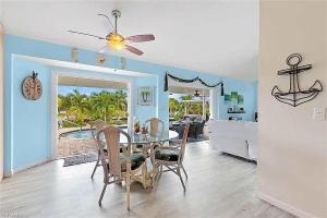 a dining room and living room with a table and chairs at Summer Getaway (Gulf-access retreat) in Cape Coral +18 photos