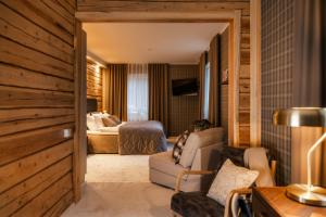 a living room with a couch and a bedroom at Skýra Retreat in Rovaniemi