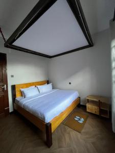 una camera da letto con un letto grande con una grande finestra di Cj VILLA a Karatu Altre 8 foto