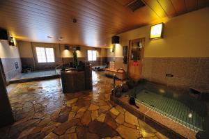 a large bathroom with a tub in a building at Dormy Inn Express Koriyama in Koriyama