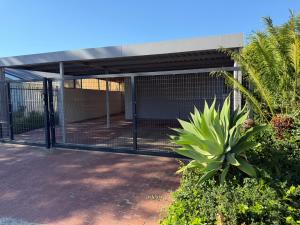 a metal gate in front of a building at Stellenbosch Serenity in Stellenbosch