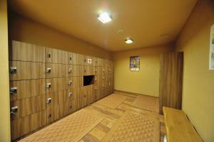 a large room with lockers in a gym at Dormy Inn Express Koriyama in Koriyama