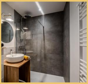 a bathroom with a sink and a shower at L'Ecrin du Lac I Studio I Sévrier in Sévrier