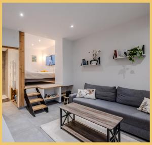 a living room with a couch and a bed at L'Ecrin du Lac I Studio I Sévrier in Sévrier