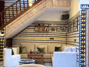 a living room with a couch and a table at Riad Safia in Rabat