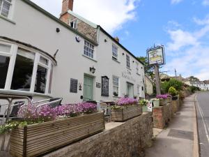 a building with flowerpots on the side of a street at Jurassic Discovery in Charmouth