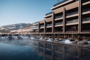 a hotel with a pool in front of a building at Hotel Solvie in Falzes