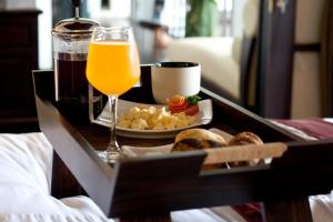 a tray of food and a glass of orange juice at Villa Binarmata in Munggu