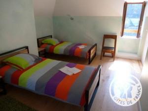 Ένα ή περισσότερα κρεβάτια σε δωμάτιο στο Maison du meunier