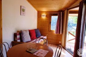 a small room with a table and a couch at Gîte 19G5412 in Soursac