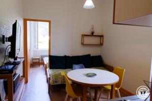 a living room with a table and a couch at Gîte ecole 2 in Soursac